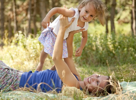 Little girl and mother in the park の写真素材