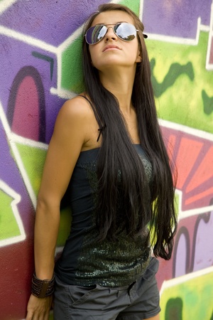 Girl near graffiti background.の写真素材