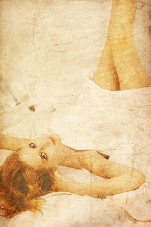 Pretty sleeping woman in white nightie lying in the bed. Photo in old image style.の写真素材