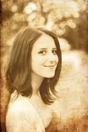 Redhead girl at summer park. Photo in old image style.の写真素材