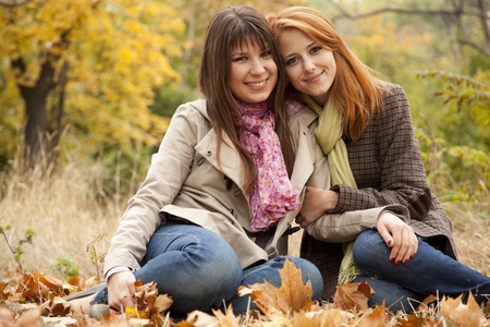 Two girls in the autumn park. Outdoor shot.の写真素材