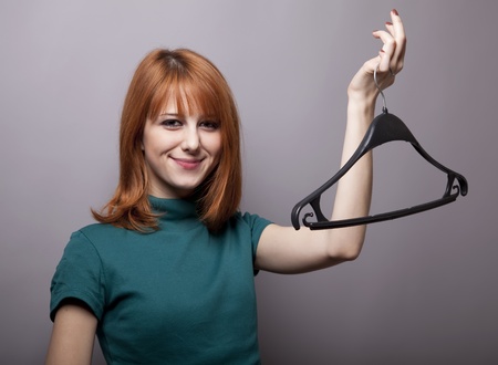 Smiling girl with hangerの写真素材