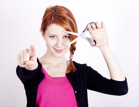 Redhead girl with scissors.の写真素材