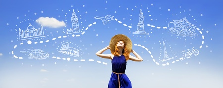 Redhead girl dreaming about traveling around the world.の写真素材