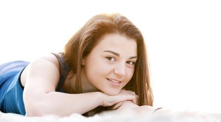 Brunette girl at the beach in sunrise.の写真素材