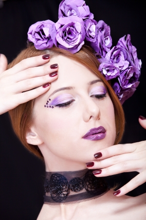 Portrait of beautiful redhead girl with style make-up and flowers.の写真素材