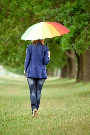 Young fashion girl with umbrella at spring outdoor.の写真素材