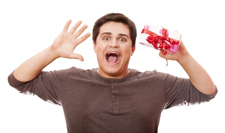 An angry man holding present box on white background.