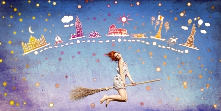 Young red-haired witch on broom flying awayの写真素材