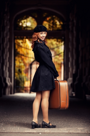 Style redhead girl with bag at the autumn street.の写真素材