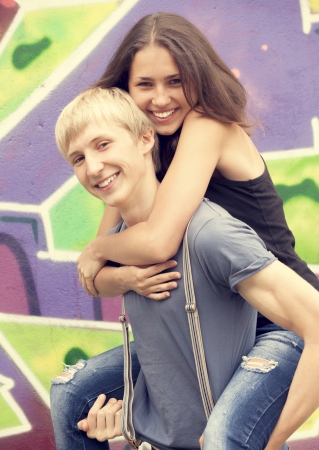 Young couple near graffiti background.の写真素材