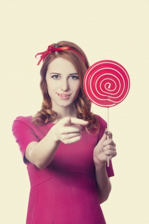 Beautiful redhead girl with lollipop. の写真素材