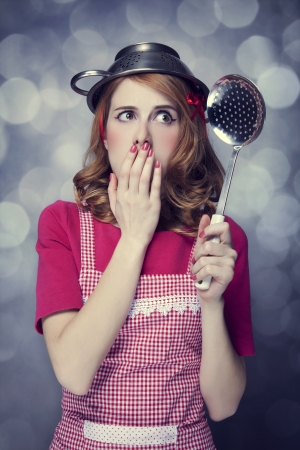 Redhead housewife with soup ladleの写真素材
