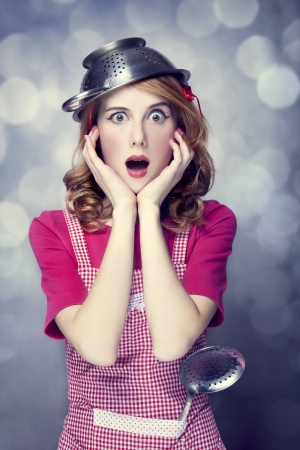 Redhead housewife with soup ladleの写真素材