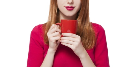 Red-haired girl with cup.の写真素材