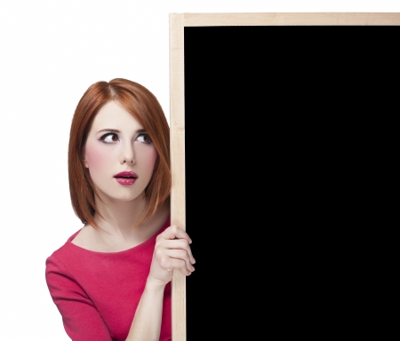 Redhead student with blackboard.の写真素材