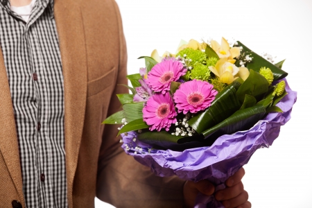 man with flowers in handの写真素材