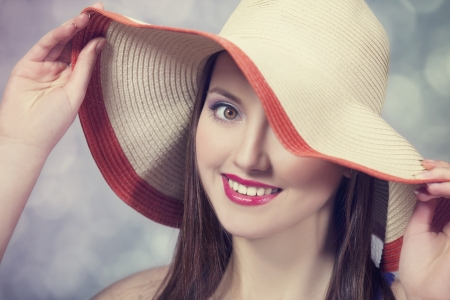 Beautiful girl in hat at bokeh backgroundの写真素材