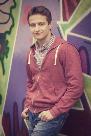 Style teen boy near graffiti background.の写真素材