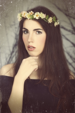 Girl with style makeup and flower. Photo in vintage color style.の写真素材