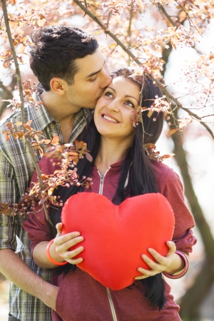 Couple Relaxing in the Park with toy heart. Spring timeの写真素材