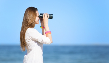 Girl with binocularの写真素材