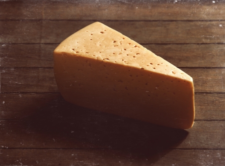 Old cheese on wood tableの写真素材