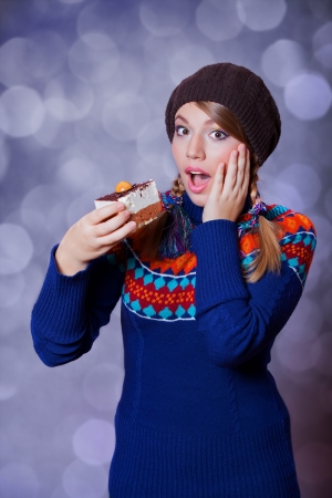 Style girl with cake and bokeh at background.の写真素材