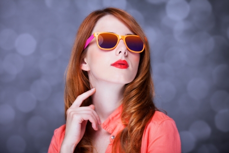 Surprised redhead girl in sunglasses.の写真素材