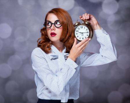 Redhead women with clock.の写真素材