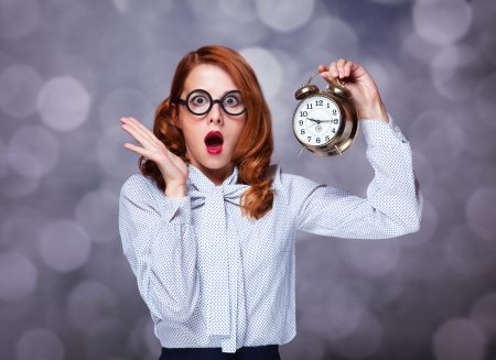Redhead women with clock.の写真素材