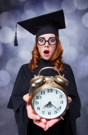 Redhead student with big clockの写真素材