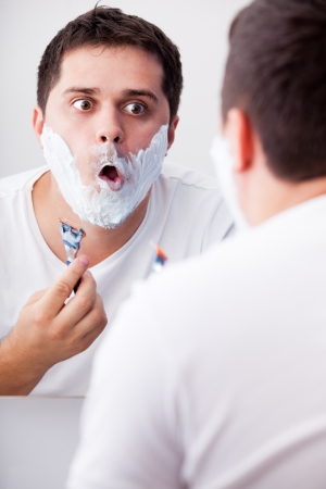 Surprised real men shaving.の写真素材