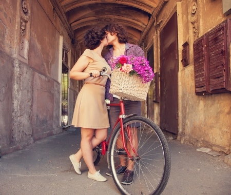 Couple with bike near house.の写真素材