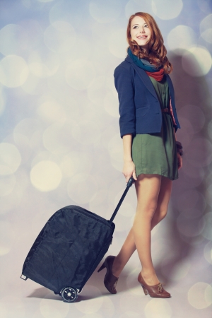 Redhead girl with a suitcaseの写真素材
