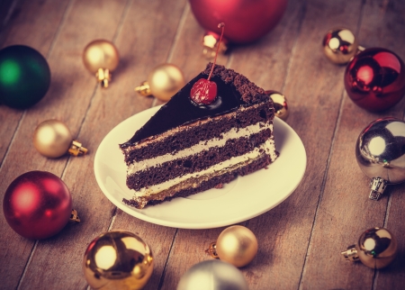 Chocolate cake and christmas gifts at backgroundの写真素材