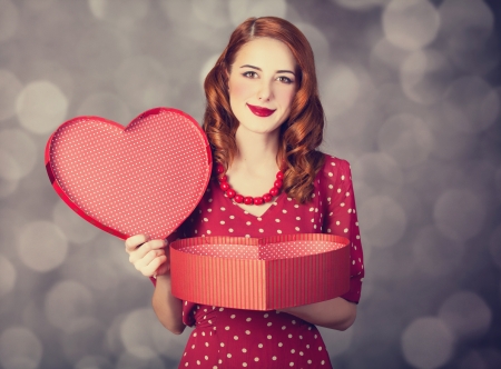 Redhead girl with gift for Valentines Day. の写真素材