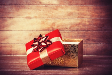 Retro gift on wooden table. Photo in vintage color image style.