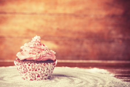Cream cake on wooden table. Photo in retro color styleの写真素材