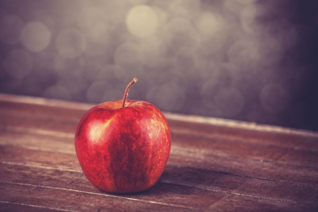 red apple on wooden tableの写真素材