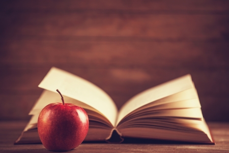 Apple and the book. Photo in old color image styleの写真素材