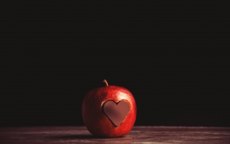 Apple with a heart cut into it and chocolate.の写真素材
