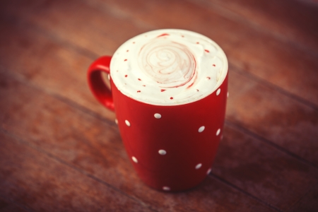 Cup of coffee on wooden table. Photo in old color image style.の写真素材