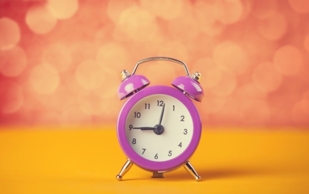 Retro alarm clock. Photo in retro color image style