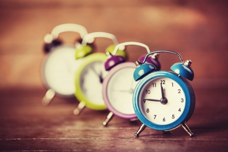 Retro alarm clocks on a table. Photo in retro color image styleの写真素材