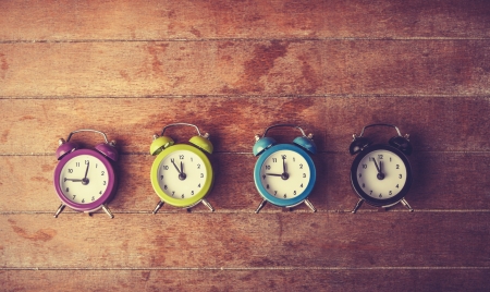 Retro alarm clocks on a table. Photo in retro color image styleの写真素材