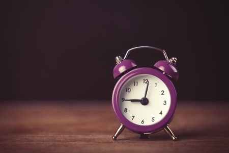 Retro alarm clock. Photo in retro color image style
