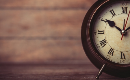 Retro alarm clock on a table. Photo in retro color image styleの写真素材
