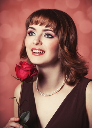 Portrait of a women with rose. Photo in 60s style.の写真素材
