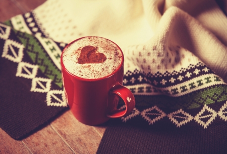 Cup with coffee and shape of the cacao heart on it and scarf. Photo with vintage vignetting.の写真素材